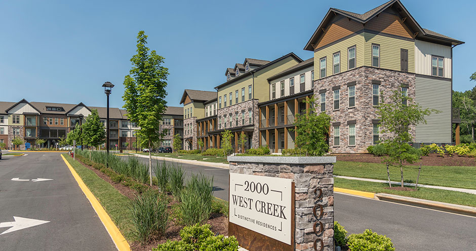 Exterior shot of an apartment building and a sign
