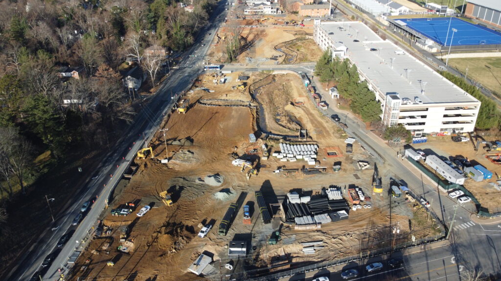 Aerial view of a construction site next to a parking garage